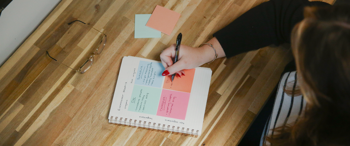 Overhead shot of a woman writing in a notebook