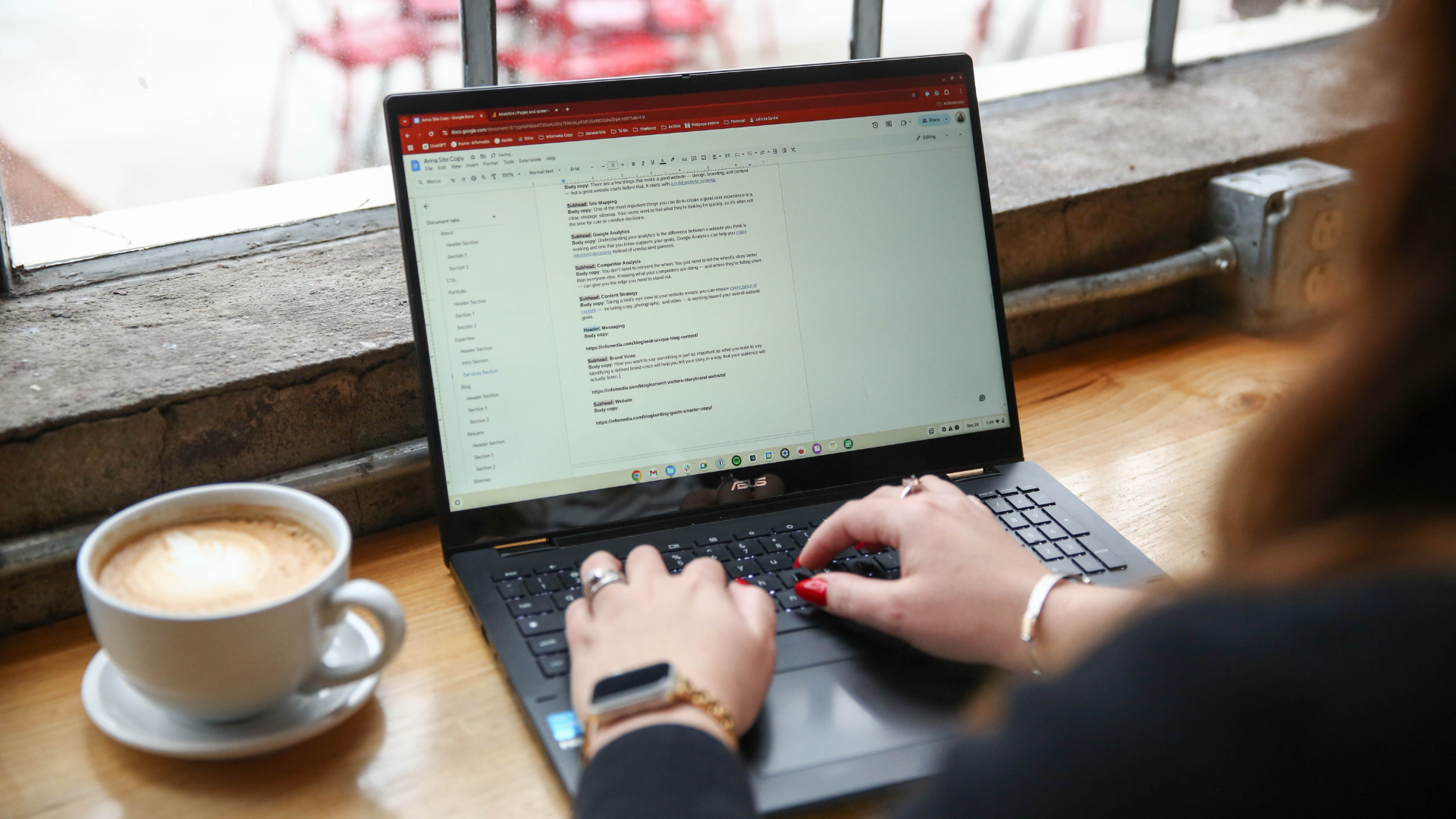 Laptop screen showing someone working on website copy with a latte on the left of the screen