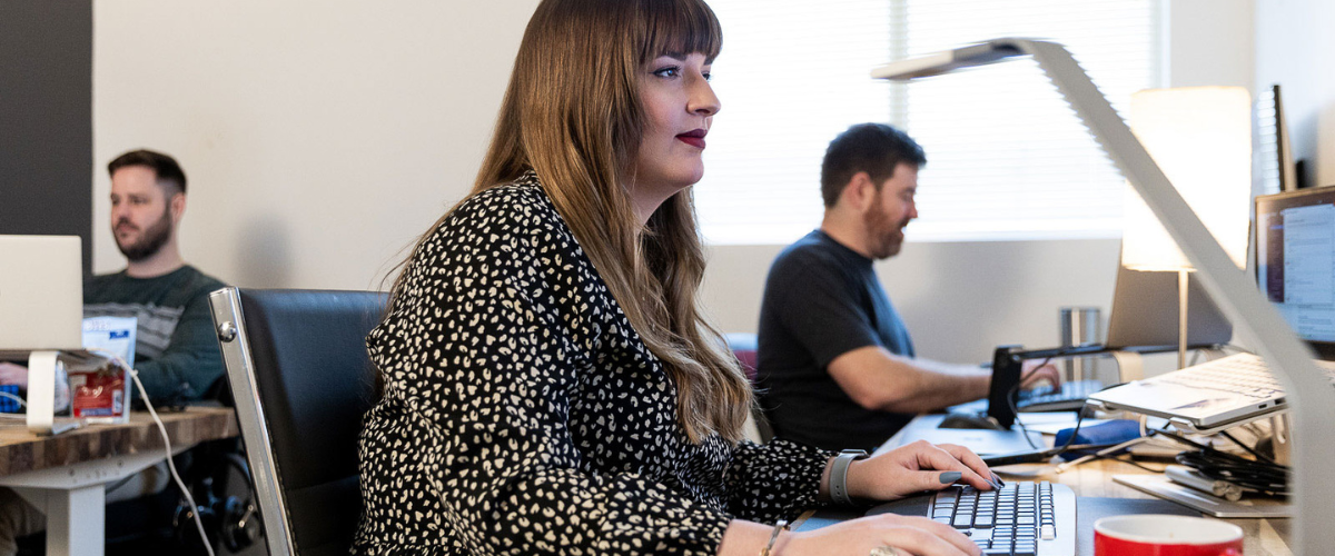 woman looking at a computer and typing