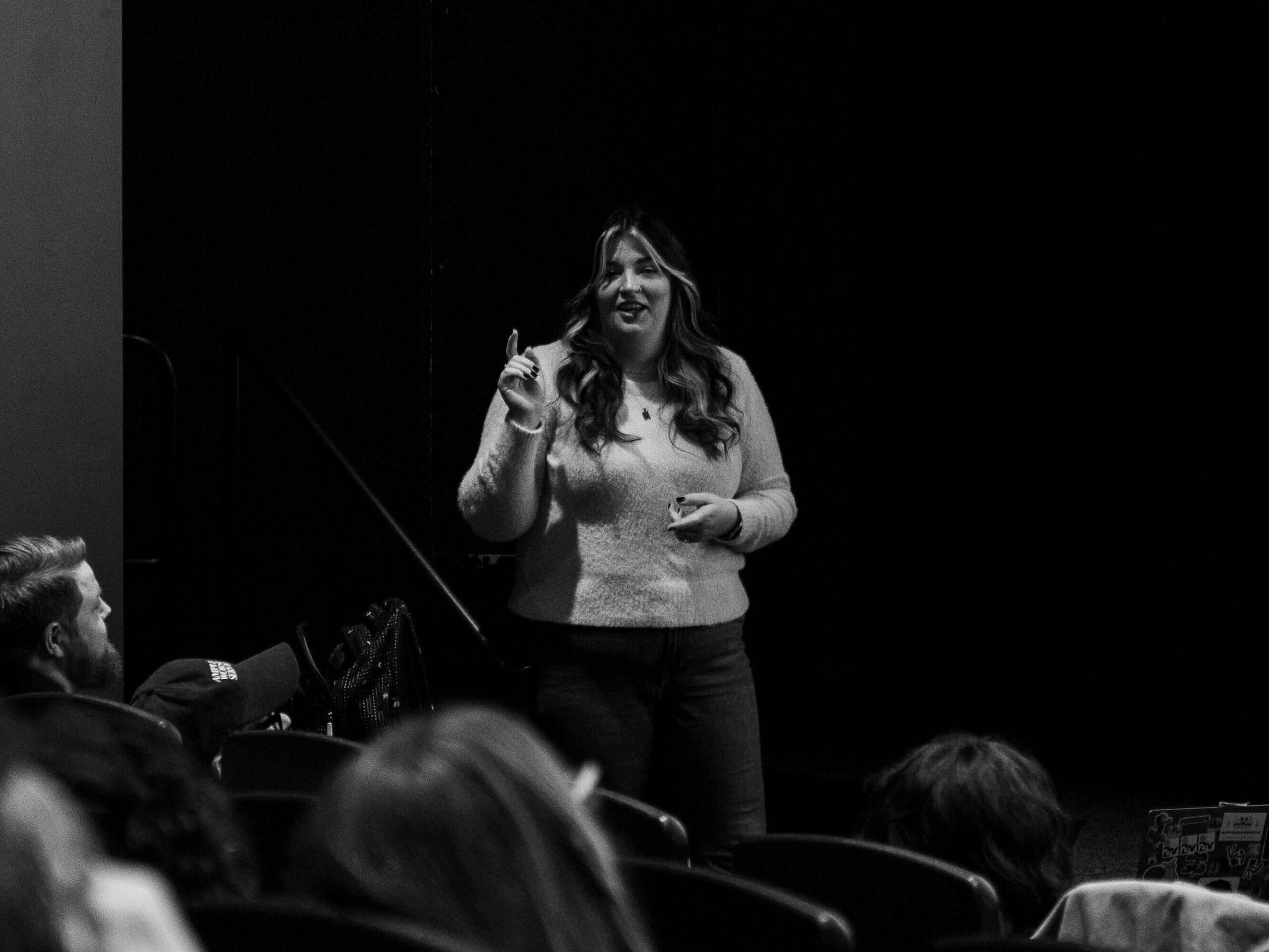 black and white photo of a woman speaking at an event