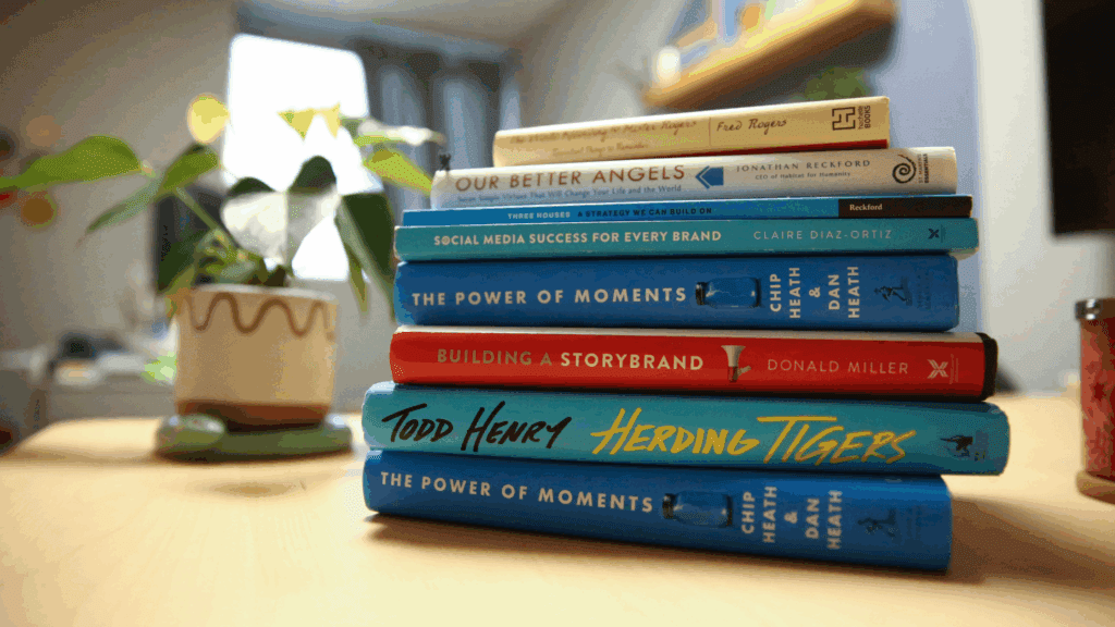 A stack of business and brand voice books sitting on a table